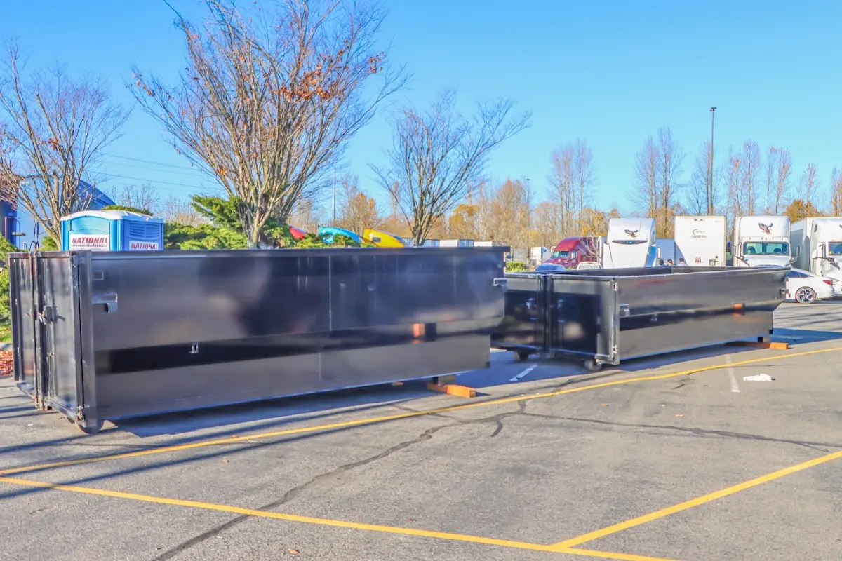 Professional dumpster rental service with roll-off container on residential driveway in Destrehan